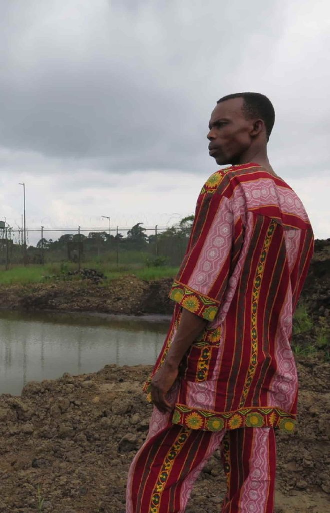 Homem em traje tradicional, contemplando a paisagem.