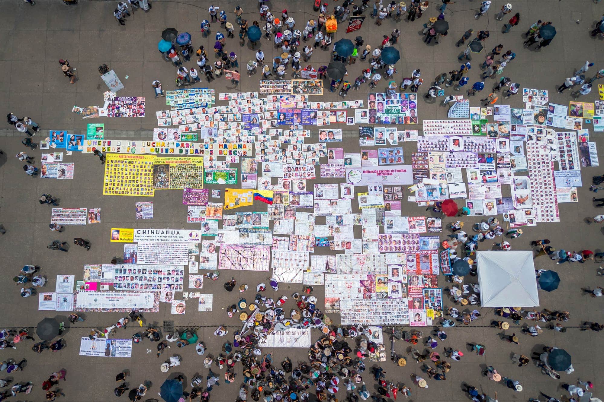 Manifestação com cartazes e pessoas reunidas.