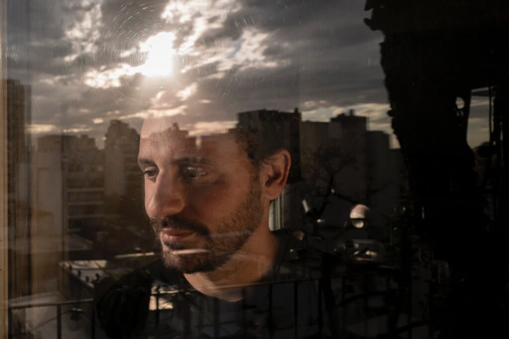 Retrato de Eyad olhando para a cidade. Ele costumava dizer que «precisava se perder na cidade de Buenos Aires para se encontrar», em Buenos Aires, Argentina, a 5 de dezembro de 2024. Foto © Anita Pouchard Serra/Amnistia Internacional